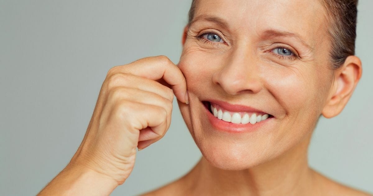 gli integratori anti-age funzionano - donna tira pelle del viso