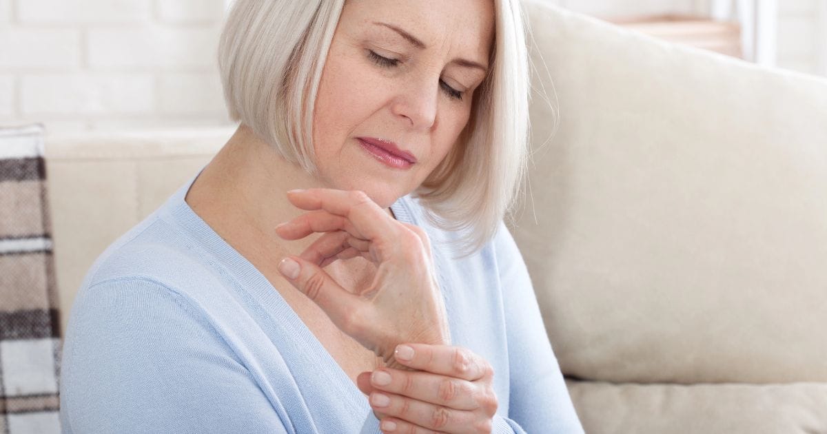 donna matura si stringe il polso che le fa male